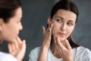 Woman examining her own face